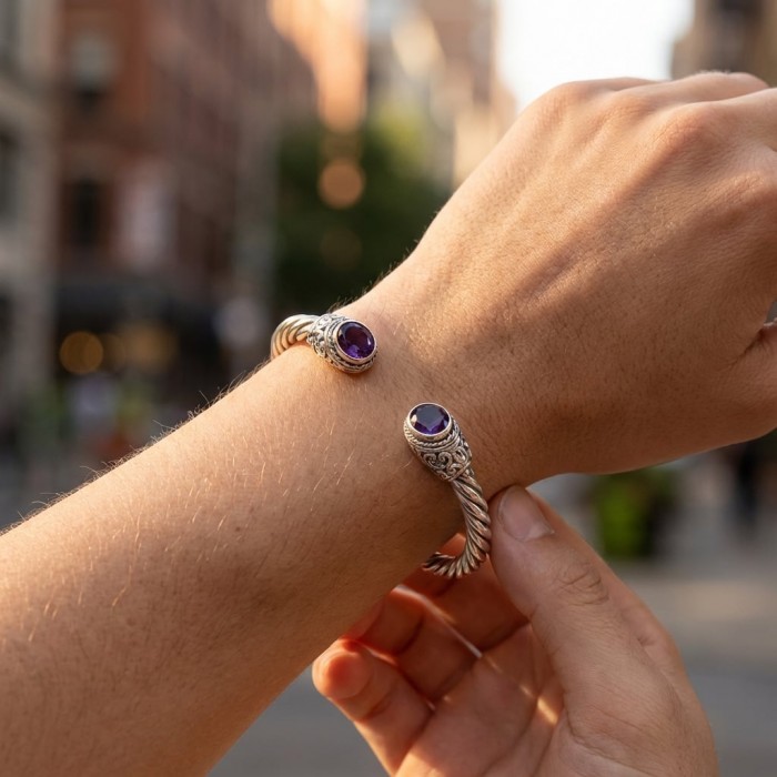Heavy and Solid authentic 10.2 carat Amethyst .925 Sterling Silver handcrafted hinged cuff bracelet - Amethyst bracelet worn on wrist, street background.