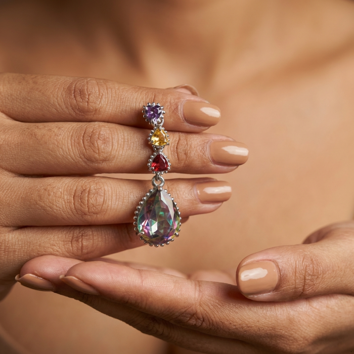 Incredible 14.2 carat Mystic Topaz .925 Sterling Silver handcrafted earrings - Close-up of Mystic Topaz earring held between fingers.