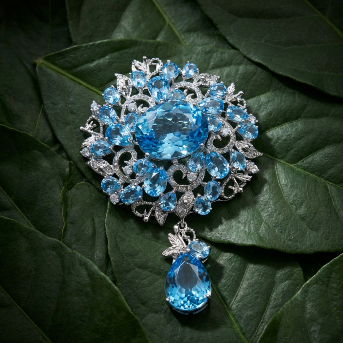 An exuberantly Large 75.5 grams Vintage style Swiss Blue Topaz .925 Sterling Silver DIPPED IN RHODIUM handmade LARGE Pendant - Brooch - Vintage blue topaz brooch on leaves, top view, ornate design.