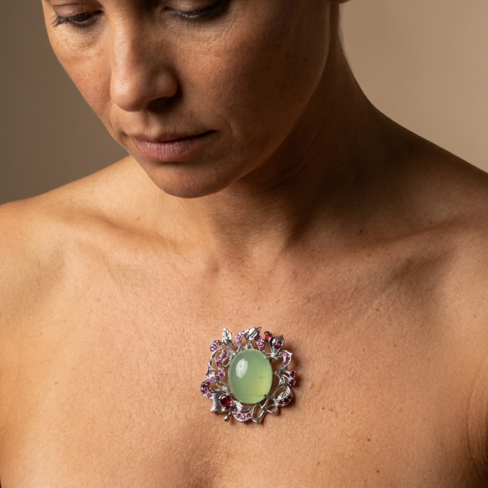 Royal quality genuine 32.5 carat Prehnite from South Africa rhodium over .925 Sterling Silver handcrafted Pendant Brooch - Prehnite brooch worn close-up on bare chest, intricate design details.