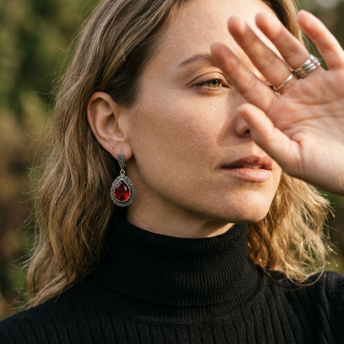 Crimson Fire Authentic 18.9 carat Garnet .925 Sterling Silver brilliantly handcrafted earrings - Side view of earring worn, featuring crimson garnet in sterling silver.