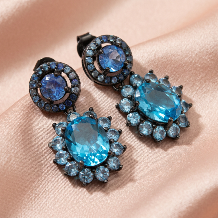 Atlantica 10.7 carat Swiss Blue Topaz .925 Sterling Silver dipped in black rhodium Handcrafted Statement earrings - Close-up of Atlantica Swiss Blue Topaz earrings on satin background.