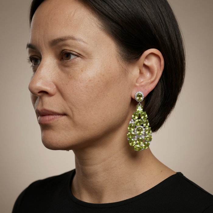 Fiesta Authentic 27.5 carat Peridot .925 Sterling Silver brilliantly handcrafted Statement earrings - Woman wearing large green peridot earrings, side view.