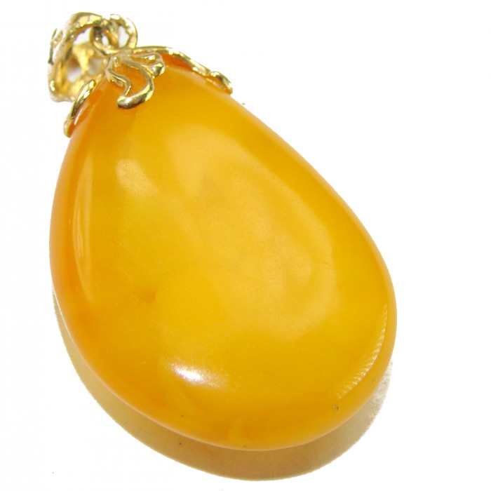 Sea Treasure Prehistoric Authentic Butterscotch Baltic Amber 18k Gold over .925 Sterling Silver beautifully handcrafted Pendant - Stone close-up of butterscotch Baltic amber pendant with gold detailing.