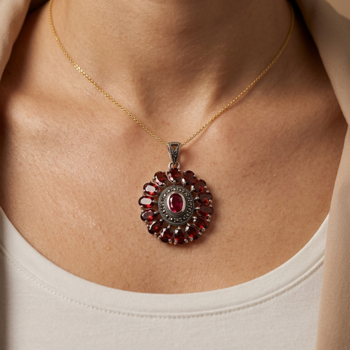 Marvelous Natural 20.8 carat Mozambique Garnet .925 Sterling Silver Handcrafted pendant - Close-up of garnet pendant worn on neck, showcasing stone detail.