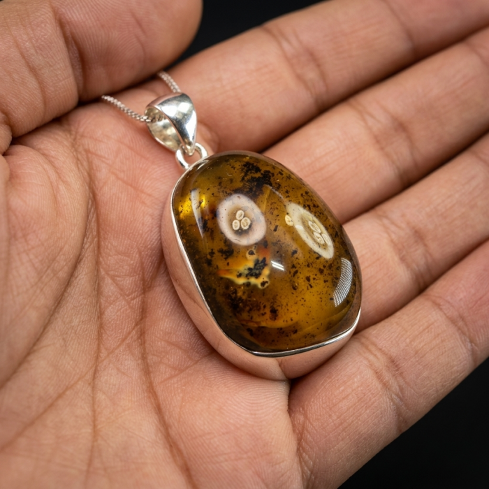 Prehistoric Authentic Baltic Amber .925 Sterling Silver beautifully handcrafted Pendant - Close-up of Baltic amber pendant in hand, .925 Sterling Silver setting.