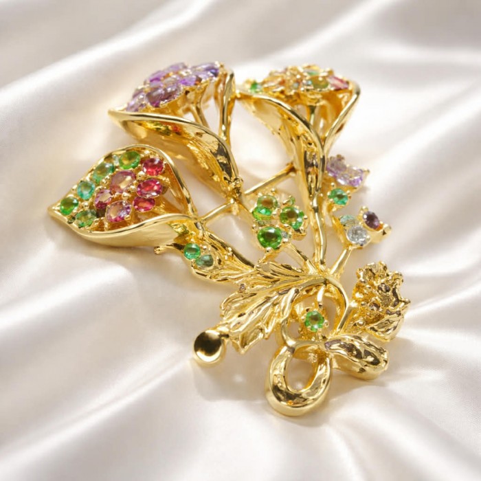 Summer Breeze Precious Multigem .925 Sterling Silver .925 Sterling Silver dipped in 18K Gold Pendant Brooch - Golden flower brooch with multicolored gems, side view on satin fabric.