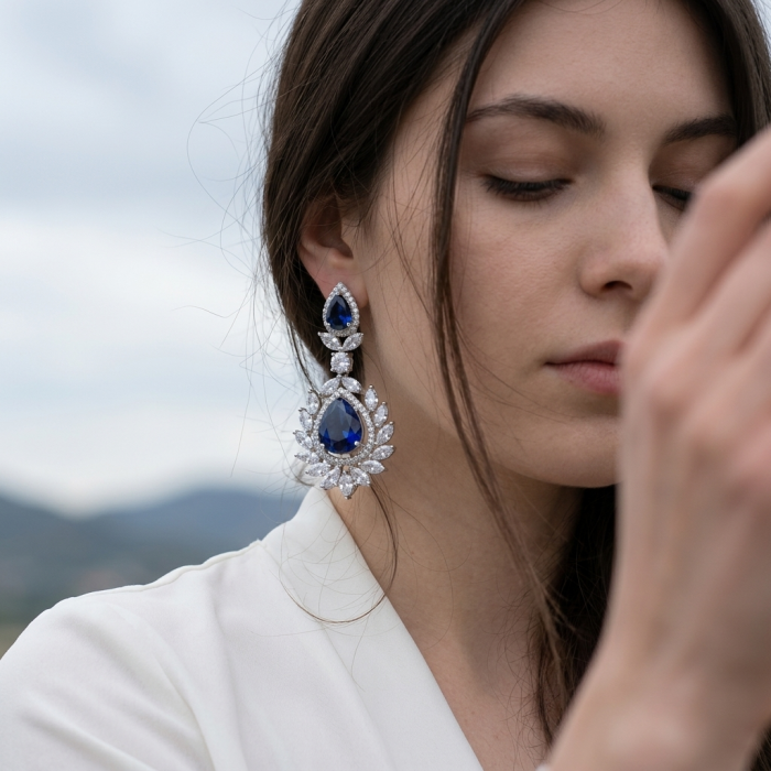 Vintage style - Giovanna - Authentic pear cut 8.9 carat Sapphire .925 Sterling Silver handcrafted earrings - Close-up of vintage sapphire earrings worn by a woman.
