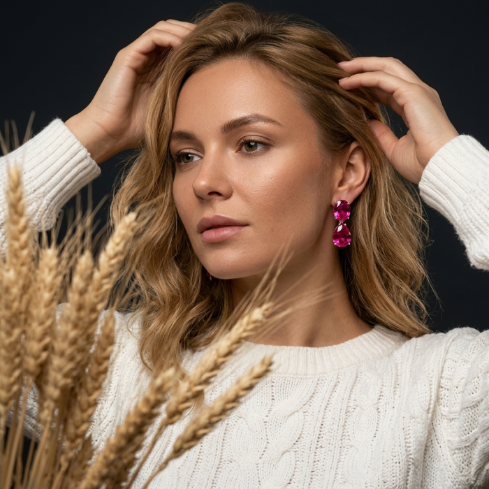 Tiffany - authentic 44.8 carat Pink Sapphire .925 Sterling Silver handcrafted Statement Earrings - Woman wearing pink sapphire earrings, side view with wheat foreground.
