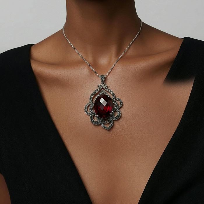 Crimson Fire Authentic 12.4 carat Garnet .925 Sterling Silver brilliantly handcrafted pendant - Garnet pendant on model, front view, black dress background.