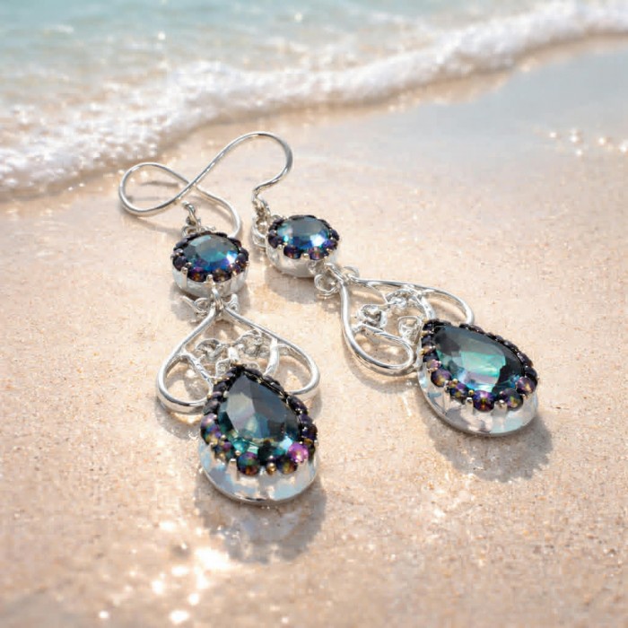 14.2 carat Mystic Topaz .925 Sterling Silver earrings - Mystic Topaz sterling silver earrings on sandy beach, close-up view.