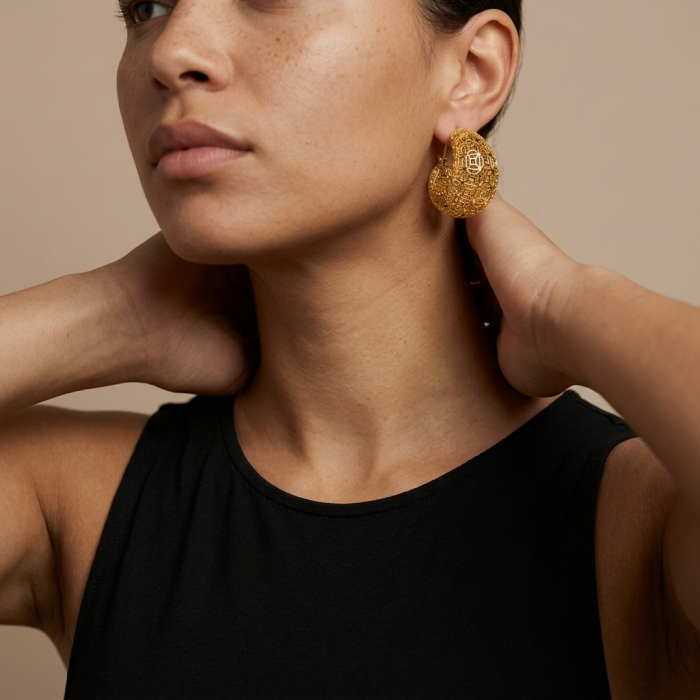Dubai Style - Golden Flowers .925 Sterling Silver dipped in 22K Gold handmade Large Earrings - Side view of woman wearing Dubai Style golden earrings.