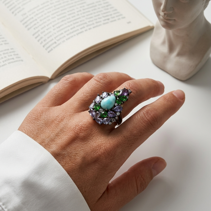 Victoria Natural 4.5 carat Larimar from Dominican Republic Tanzanite .925 Sterling Silver dipped in black rhodium handcrafted size 6 1/4 - Victoria Natural Larimar ring worn on hand, open book in background