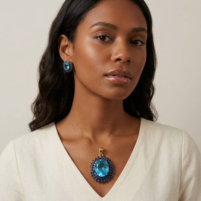 Vintage style oval cut 26.8 carat Swiss Blue Topaz .925 Sterling Silver DIPPED IN 22K Gold handmade Pendant - Woman wearing vintage style blue topaz earrings and necklace.