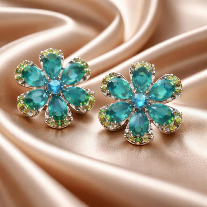 Amazonia - 339.8 carat Colombian Emerald .925 Sterling Silver handmade Statement Earrings - Floral emerald earrings on satin fabric, front view.