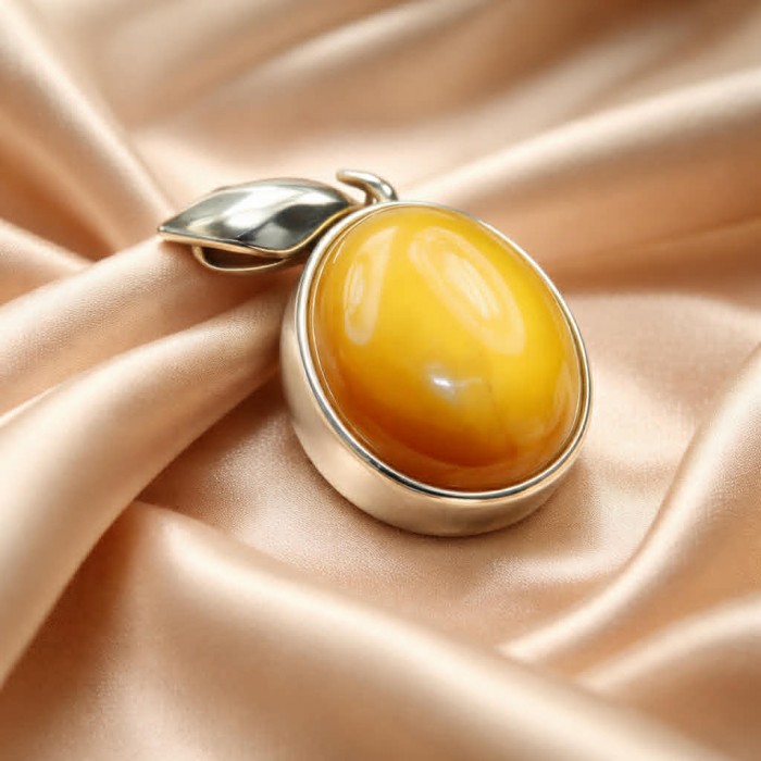 Prehistoric Authentic Baltic Amber .925 Sterling Silver beautifully handcrafted Pendant - Close-up of Baltic amber in sterling silver setting on satin fabric.