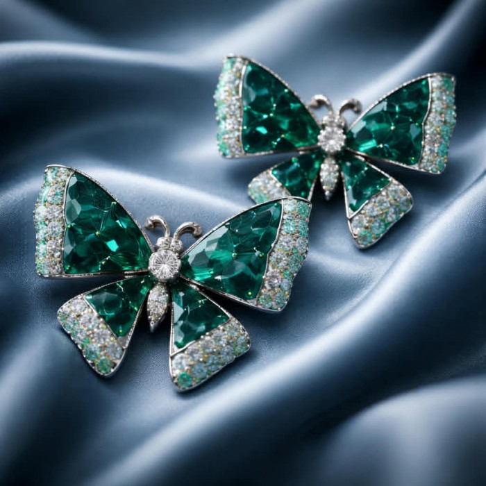 Incredible green Butterflies genuine 11.5 CARAT Emerald .925 Sterling Silver handcrafted Earrings - Green butterfly brooches with emerald and diamond detail on silk background.