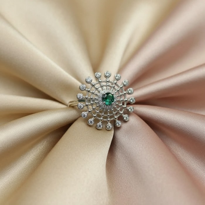 0.7 carat natural Colombian Emerald .925 Sterling Silver handmade Statement Ring size 8 1/4 - Top view of emerald ring on champagne silk fabric background