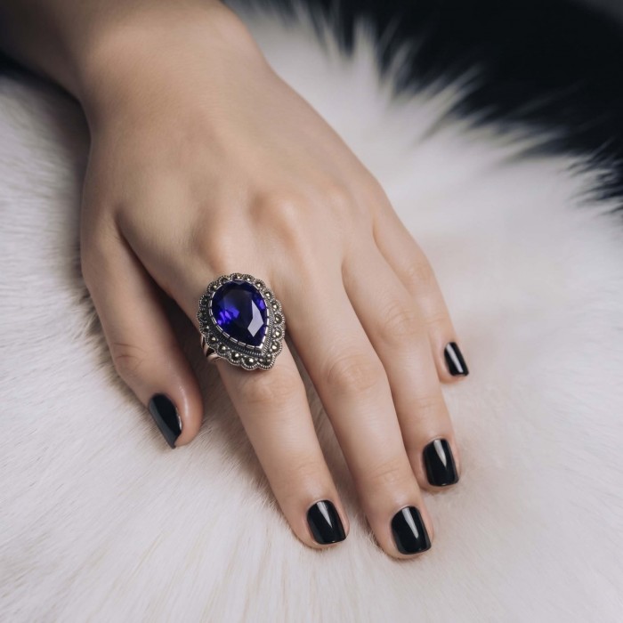 Julietta 12.8 carat London Blue Topaz Marcasite .925 Sterling Silver handmade Statement Ring size 6 - Julietta blue topaz ring on hand, black nails, white fur background.