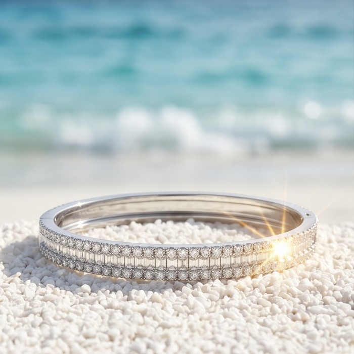 Veronica - Precious 6.7 carta White Topaz rhodium over .925 Sterling Silver Statement bracelet - Bracelet on sand with sea background, showcasing stones and sparkle