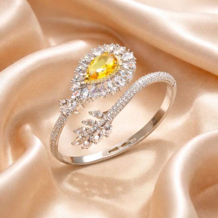 Dolce Vita - Precious Natural 18.5 carat yellow Sapphire .925 Sterling Silver handcrafted LARGE bracelet - Elegant ring with yellow sapphire on satin background, top view.