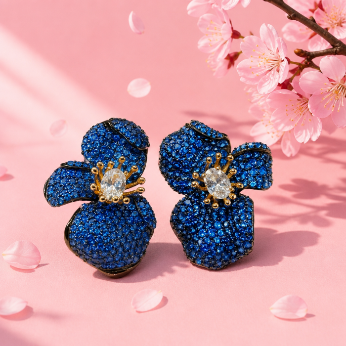 Amazonia - 38.8 carat pave Colombian Sapphire 2 tones .925 Sterling Silver handmade Statement Earrings - Blue sapphire flower earrings on pink background with blossoms.