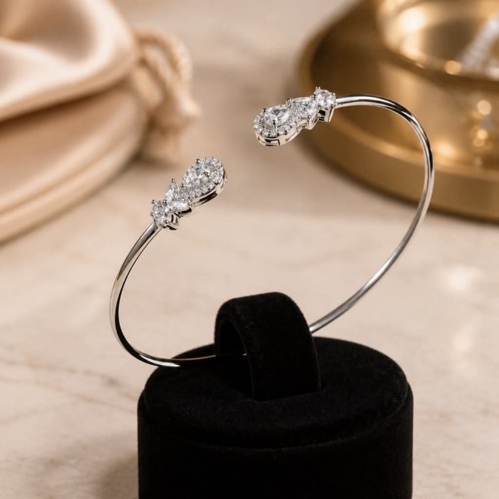 Precious Light Natural 5.2 carat White Topaz .925 Sterling Silver dipped in rhodium bracelet - Elegant bangle with white topaz, close-up view on display stand.