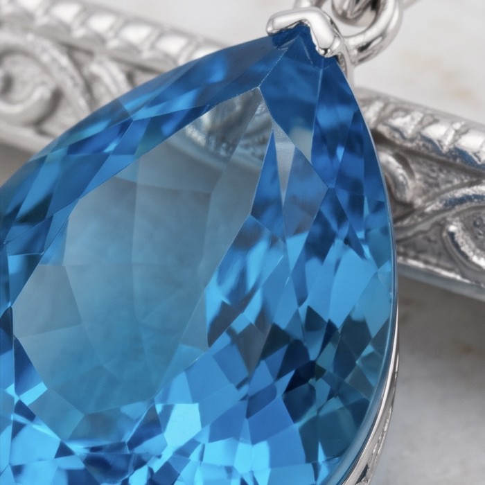 Tiffany Incredible pear cut 22.4 carat Swiss Blue Topaz rhodium over .925 Sterling Silver handcrafted pendant - Stone close-up of Tiffany pear cut 22.4 carat Swiss Blue Topaz necklace.