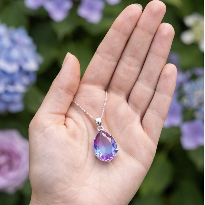 Spectacular Genuine 8.2 CARAT Alexandrite .925 Sterling Silver .925 Sterling Silver handcrafted Pendant - Hand holding Alexandrite necklace, stone close-up, floral background