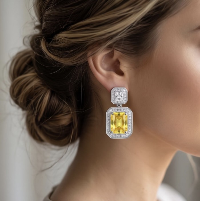 Art Deco - Luxurious baquette cut 8.5 carat Yellow Sapphire rhodium over .925 Sterling Silver handcrafted earrings - Close-up of Art Deco yellow sapphire earrings worn on ear
