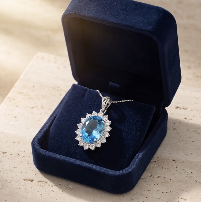 Tiffany Incredible oval cut 12.4 carat Swiss Blue Topaz rhodium over .925 Sterling Silver handcrafted pendant - Oval blue topaz necklace in box, angled top view