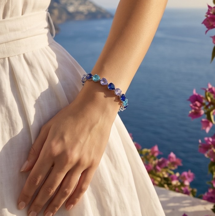 14.8 carat yellow Sapphire Apatite Amethyst 9.2 carat Sapphire black rhodium over over .925 Sterling Silver handmade bangle Bracelet - Bracelet with sapphires, apatite, amethyst worn on a hand near the sea.