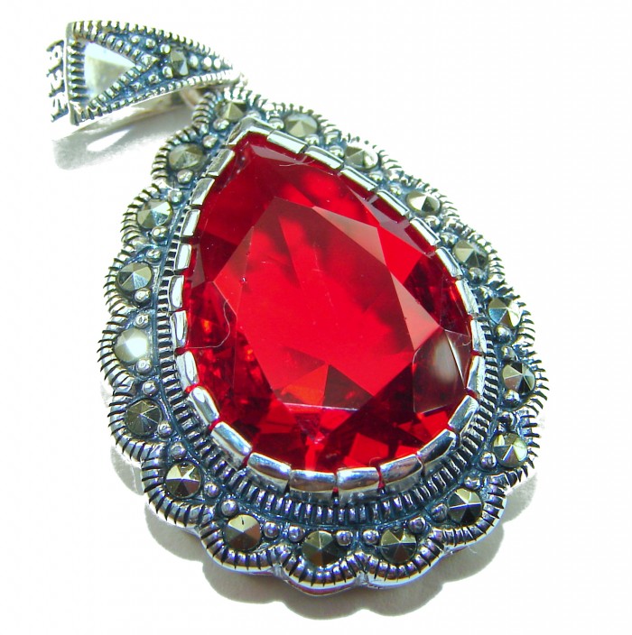 Crimson Fire Authentic 12.4 carat Garnet .925 Sterling Silver brilliantly handcrafted pendant - Close-up of crimson garnet pendant with decorative silver setting.