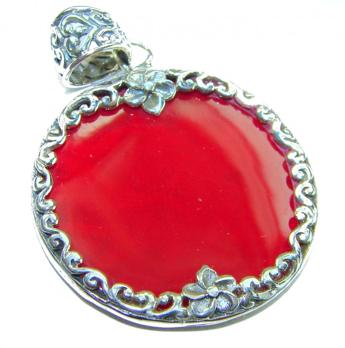 Bright Energy Authentic Coral .925 Sterling Silver Bali handmade pendant - Close-up of red coral pendant with silver floral edging and bail detail.