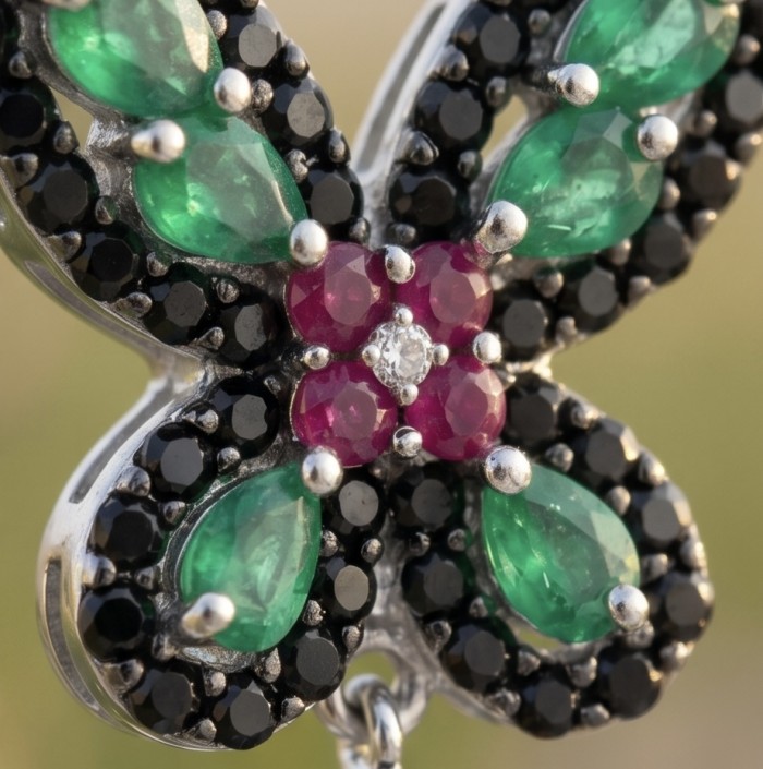 RARE BEAUTY! Valentina 27.2 carat CARVED Emerald Sapphire .925 Sterling Silver dipped in rhodium Statement handcrafted earrings - Close-up of emerald and sapphire butterfly jewelry detail.