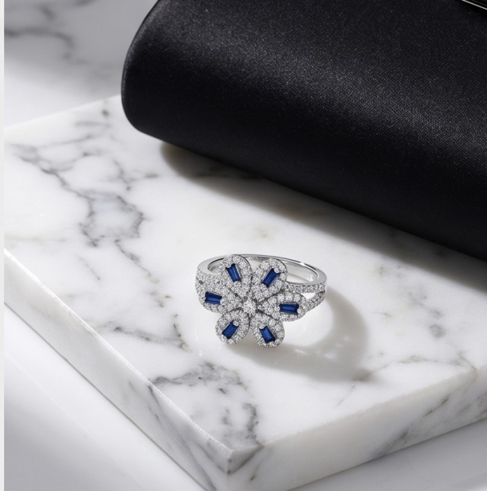 Art deco - Real 3.2 carat Sapphire Italy Made Silver Sterling Silver spinning ring s 7 - Top view of sapphire and diamond flower ring on marble surface.