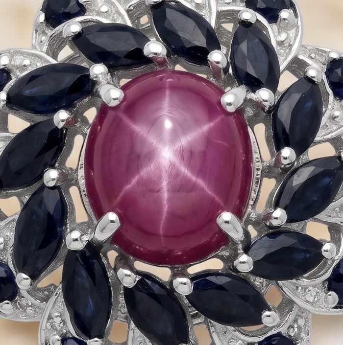 15.2 carat authentic Mozambique Star Ruby rhodium over .925 Sterling Silver handmade Pendant - Close-up of 15.2 carat Mozambique star ruby with dark blue stones.