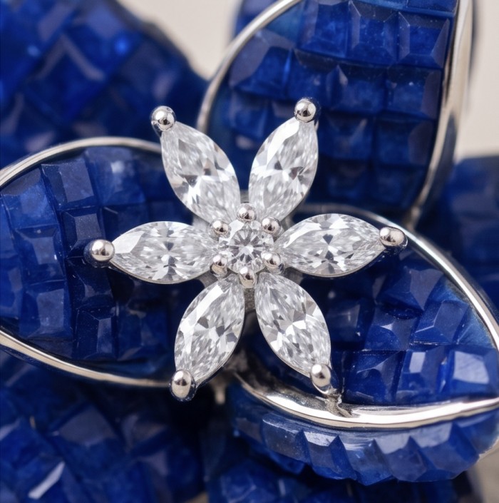 Born to Glam authentic mystery setting 18.2 carat Colombian Sapphire .925 Sterling Silver handcrafted earrings - Diamond flower close-up on blue gemstone jewelry background.