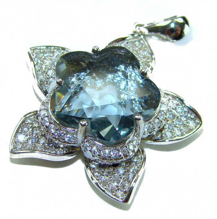 Sublime genuine 15.5 carat Tanzanite .925 Sterling Silver handmade Pendant - Flower-shaped Tanzanite pendant with diamond detailing, close-up view.