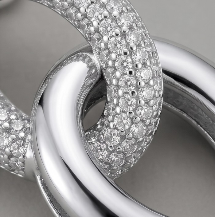 Top quality Sublime 1.38 carat pave White Topaz rhodium over .925 Sterling Silver handcrafted Earrings - Close-up of intertwined rhodium jewelry with white topaz pave stones.