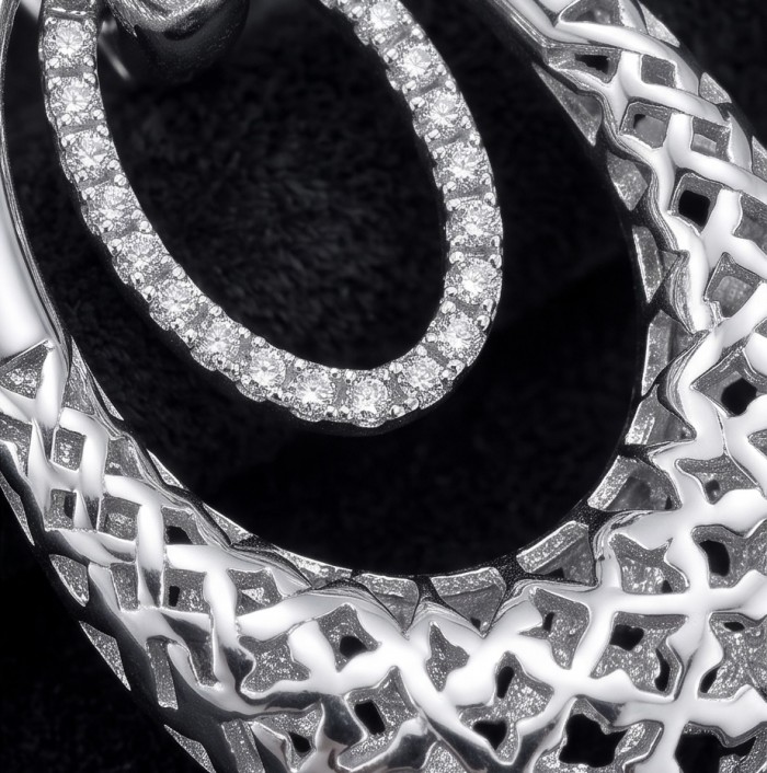 Highly Polished Fancy design 3.2 carat White Topaz .925 Sterling Silver Italy made Earrings - Close-up of intricate white topaz and sterling silver jewelry design.