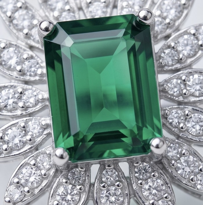 Elizabeth 5.8 carat Colombian Emerald 2.3 carat Moissanite .925 Sterling Silver dipped in Rhodium handcrafted Ring size 7 1/4 - Close-up of Colombian emerald with moissanite accents in a floral design.