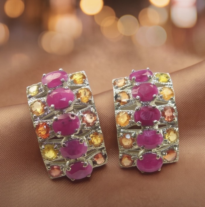 Giovanna - 8.5 carat Ruby Orange Sapphire .925 Sterling Silver handcrafted incredible earrings - Ruby and orange sapphire ring close-up on a fabric background
