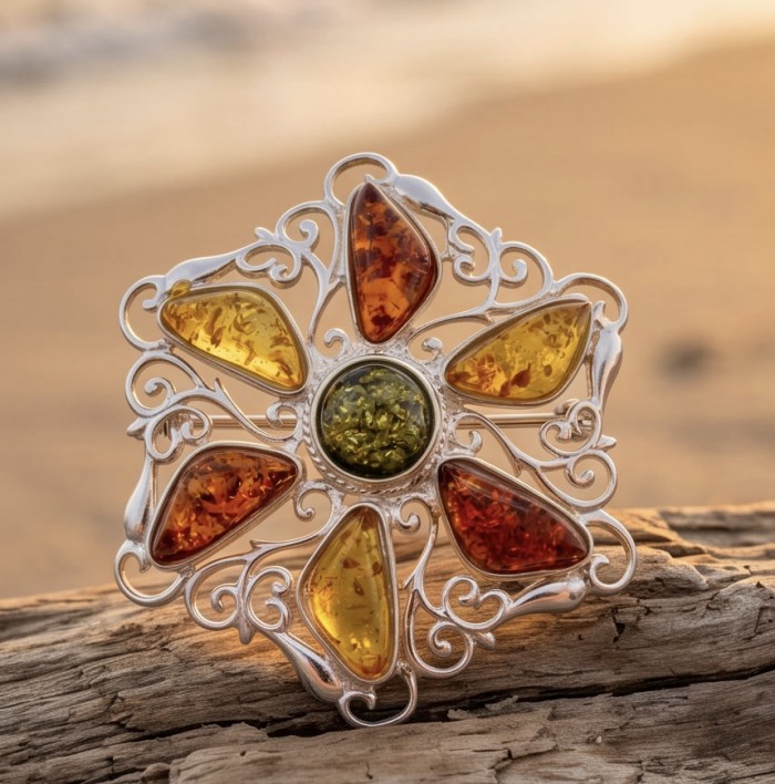 Golden Harmony Authentic Baltic Amber rhodium over .925 Sterling Silver handcrafted pendant - Front view of decorative Baltic amber brooch on driftwood background.