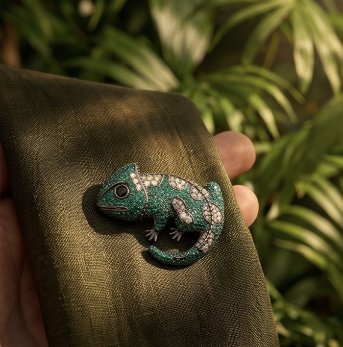 Spectacular - Chameleon Lizard 7.2 carat Tsavorite Garnet black rhodium over .925 Sterling Silver handmade Brooch - Chameleon brooch with tsavorite garnets on green fabric, close-up shot.