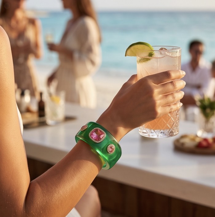 Candy Store - Modern Design Natural Green Raisin Pink Topaz .925 Sterling Silver bracelet - Worn on wrist with drink, beach background, jewelry close-up.