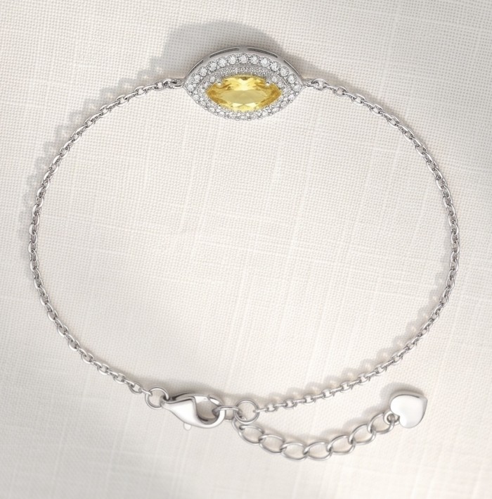 Luxurious 4.5 carat marquoise cut Yellow Sapphire .925 Sterling Silver handcrafted Statement Bracelet - Side view of yellow sapphire bracelet on textured background.