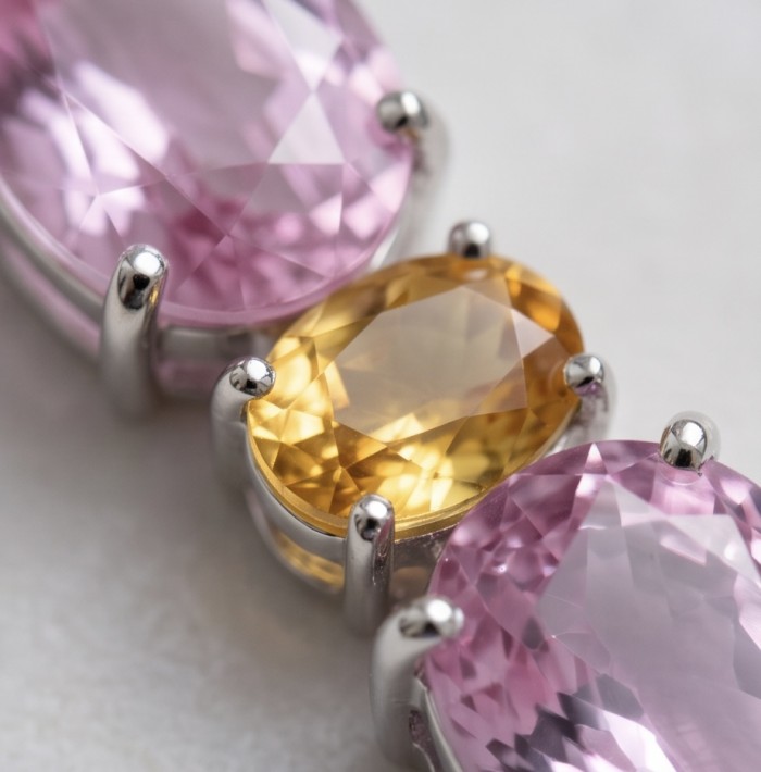 Incredible pear cut 15.8 carat Pink Topaz Rhodium over .925 Sterling Silver handcrafted pendant - Close-up of pink topaz and yellow gemstone in a rhodium setting.