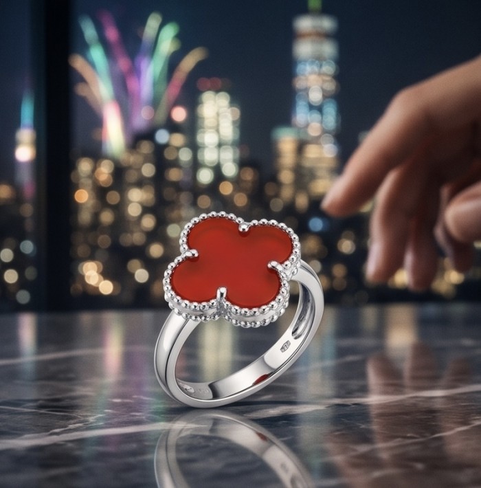A four-leaf clover Coral .925 Sterling Silver handcrafted ring s. 6 1/4 - Four-leaf clover coral ring on marble surface, city skyline background.