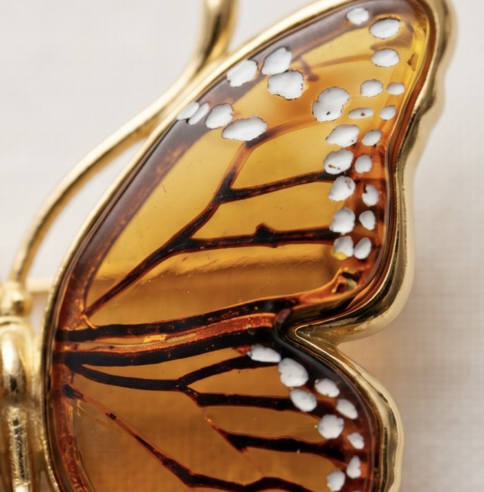 Golden Butterfly Authentic carved Baltic Amber 18K Gold over .925 Sterling Silver handcrafted pendant - Close-up of butterfly wing detail, carved amber with gold accents